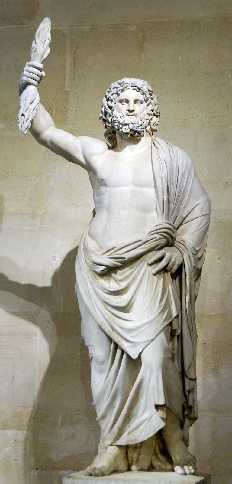 Roman marble statue of Jupiter, bearded, a cloak over his left arm, raising a thunderbolt.